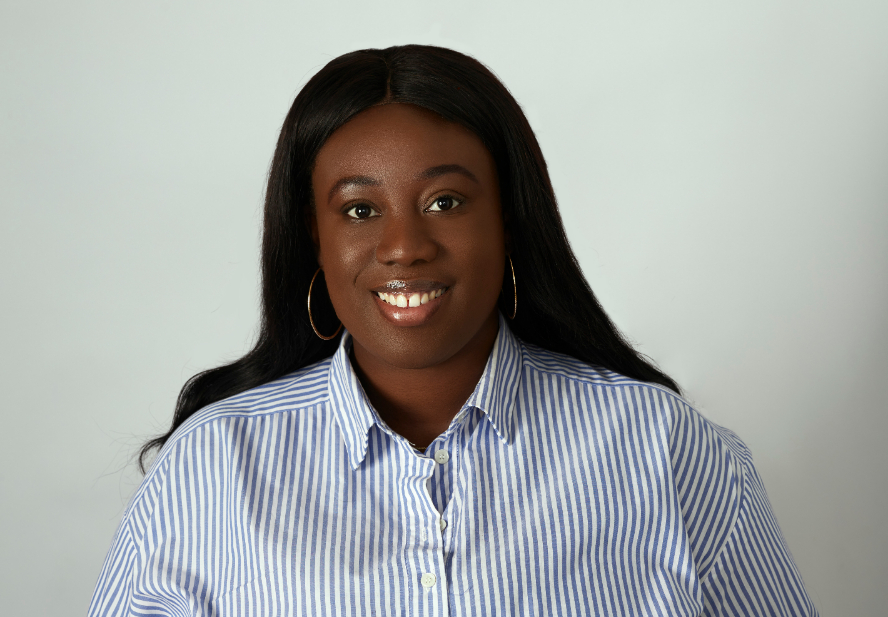 Shalewa Olanrewaju smiling for a work photo op